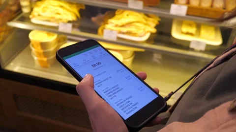 Phone in hands of client against cafe window. Stock Footage 286047120