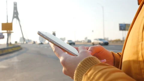 The phone is in the hands of the girl. Close-up. To write a message. Slow motion Stock Footage 118013959