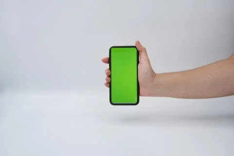 Phone held by a woman's hand vertically Stock Photos