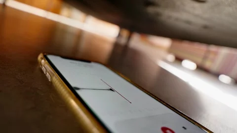 Phone hidden under bed or sofa with voice recording app listening and capturing Video stock 311836630