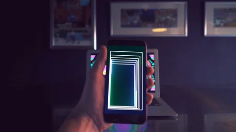 A phone in his hand close-up with the addition VFX Stock Footage 129515538
