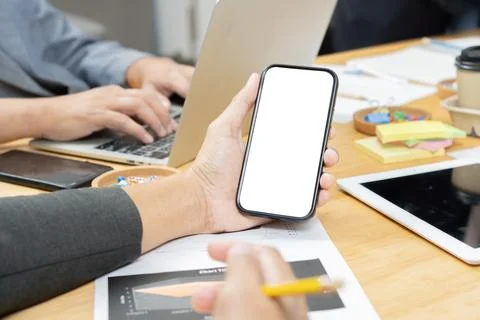 Phone with isolate screen on multicultural professional businesspeople hand.. Stock Photos