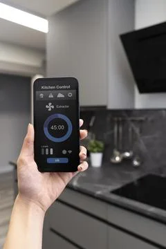 Phone with kitchen control close up Stock Photos