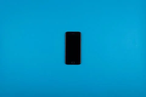 The phone lies on a blue background Stock Photos