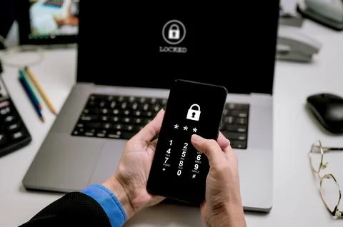 Phone lock code. Protect your laptop with two-factor authentication. Stock Photos