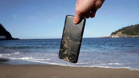 A phone lost on the beach Stock Photos
