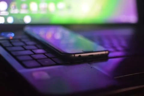 Phone lying on laptop keyboard Stock Photos