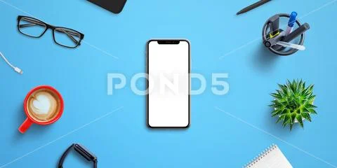 Phone mockup on blue office desk surrounded by office supplies PSD-Vorlage