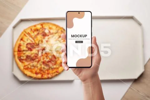 Phone mockup for food ordering with pizza in background PSD Template