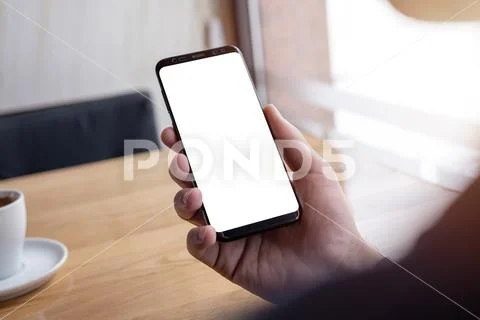 Phone mockup with thin edges in man hand PSD Template