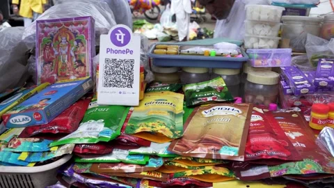 Phone Pe UPI QR code scanner at street side vendor selling incense sticks for Stock Footage 301849734