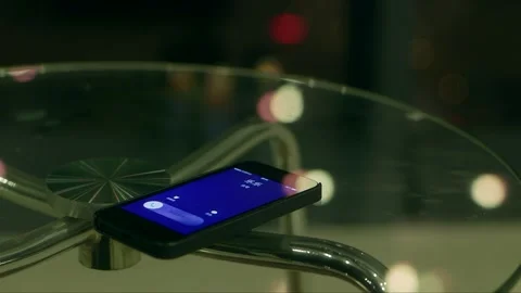 The phone placed on the coffee table receives a call notification Stock Footage 261642467