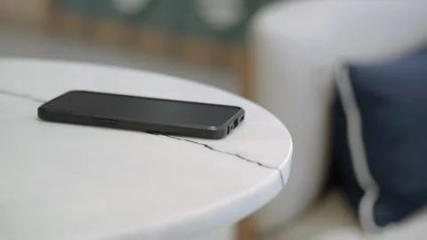 Phone resting on a table. lost smart phone concept Stock Footage 332751213