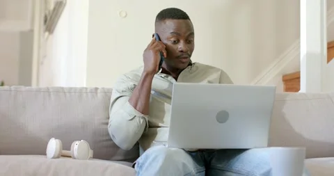 Phone ringing causing mid-adult African American man answering referencing Stock Footage 343838157