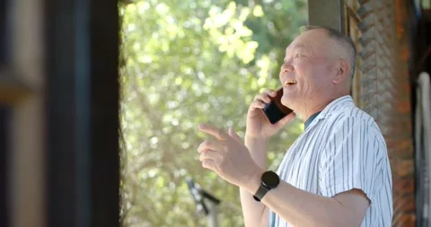 Phone ringing, Senior Asian man answering phone at porch, chatting, smiling, Stock Footage 342494831