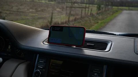 Phone running navigation in the car. Navigating on the phone while traveling Stock Photos