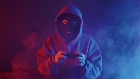 Phone scammer in a mask writes a text message Stock Footage 201603569