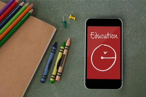 Phone on a school table with school icon on screen Foto stock