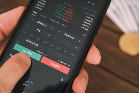 On the phone screen of the application for buying cryptocurrency. Stock Photos