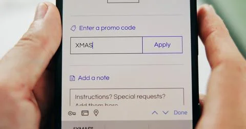 Phone screen, promo code and hands of person for xmas, sale or store discount Stock Photos