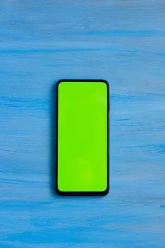 Phone smartphone, green screen on Blue wood background top view Stock Illustration