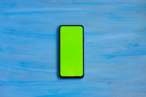 Phone smartphone, green screen on Blue wood background top view Stock Illustration