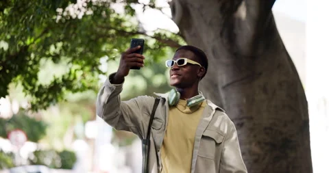 Phone, streaming and student or black man in city for communication, social Stock Footage 323253870
