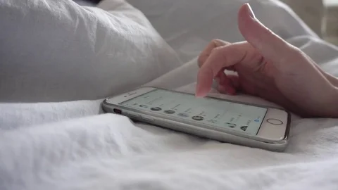 Phone swipe screen touch in bed 4K Stock Footage 83053597