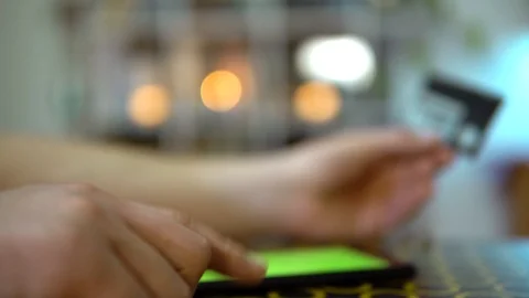 The phone is on the table, the guy doubts whether it is worth paying for the Stock Footage 127117843