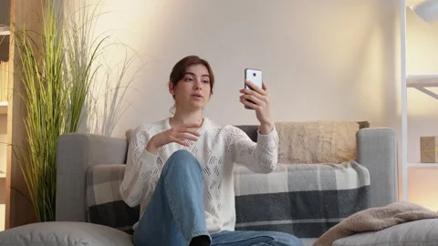 Phone video call mobile communication woman home Stock Footage 172999115