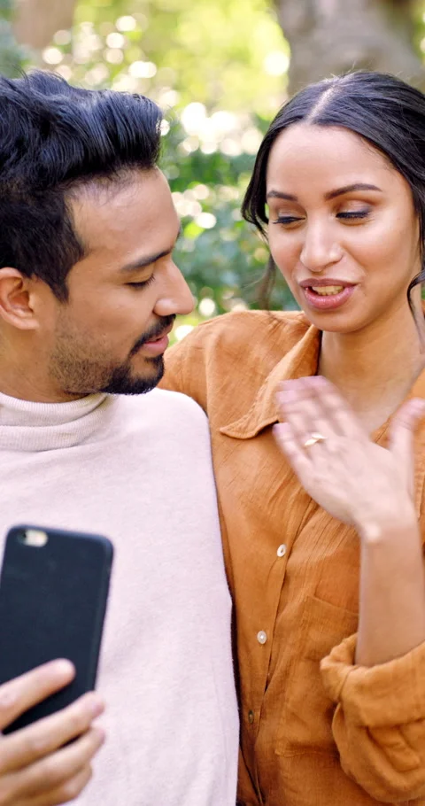 Phone, video call or couple with wedding ring in park, engagement announcement Stock Footage 336695902