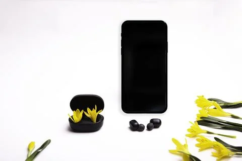 Phone on a white background and wireless headphones Fotos de archivo