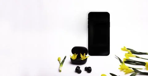 Phone on a white background and wireless headphones Stock Photos