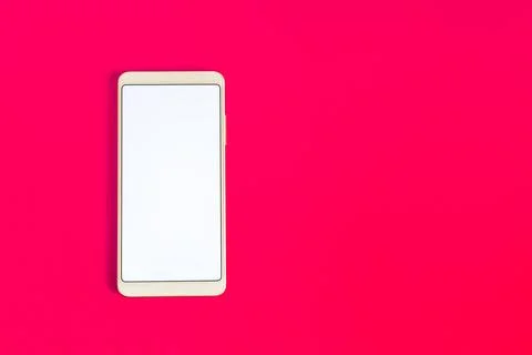 A phone with a white screen on a red background. Stock Photos