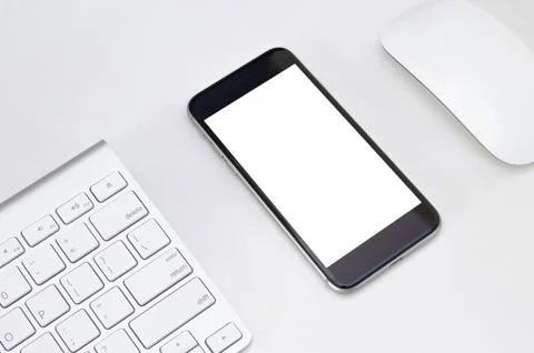 Phone white screen on white table workspace Stock Photos