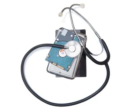 Phonendoscope on computer hard drives. Stock Photos