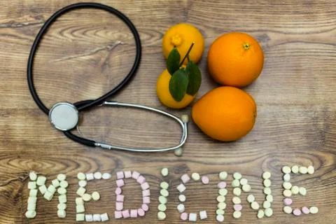 Phonendoscope, two lemons, two oranges with the word: MEDICINE. Stock Photos