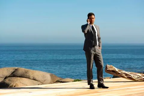 Phoning by the sea Stock Photos