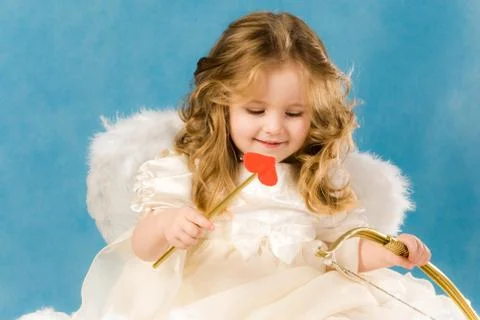 Photo of adorable female cupid holding bow Stock Photos
