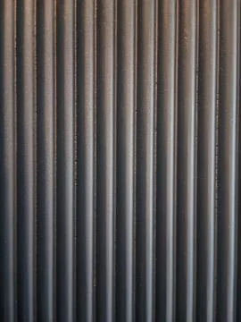 A photo of a background with a textured pattern of vertical lines in a dark.. Stock Photos