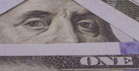 Photo of Benjamin Franklin's eyes in a triangular frame of 100 dollar bills Stock Photos