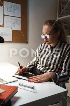 Photo of blonde cute woman architect wearing glasses designing draft on graph Stock Photos