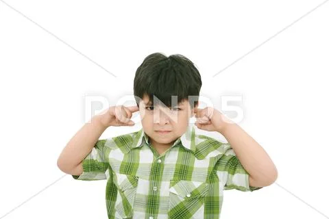Photo of a boy with his fingers in his ears. Stock Photos