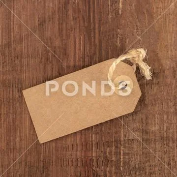 A photo of a brown kraft paper label or price tag, shot from the