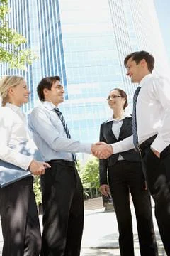 Photo of business partners handshaking at meeting in natural environment Stock Photos
