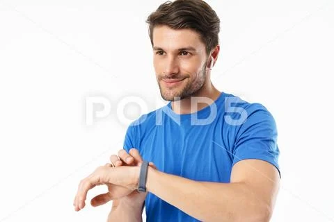 Photo closeup of caucasian man in casual t-shirt smiling and using wristwatch Stock Photos