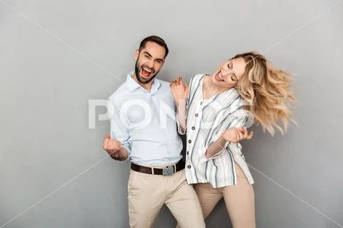 Photo closeup of cute couple in casual clothing smiling and dancing Stock Photos