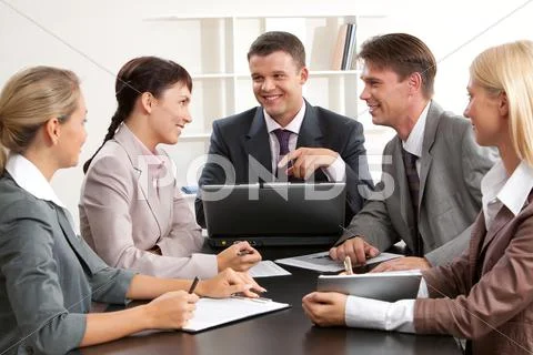 Photo of confident business people looking at woman while planning work at meeti Stock Photos