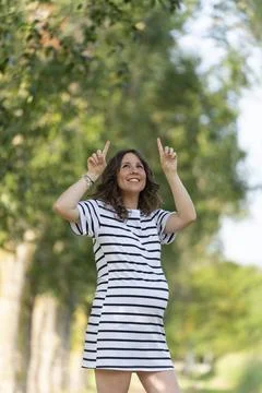 Photo with copy space to insert something with a pregnant woman pointing up Stock Photos