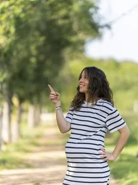 Photo with copy space to insert something with a pregnant woman pointing up Stock Photos
